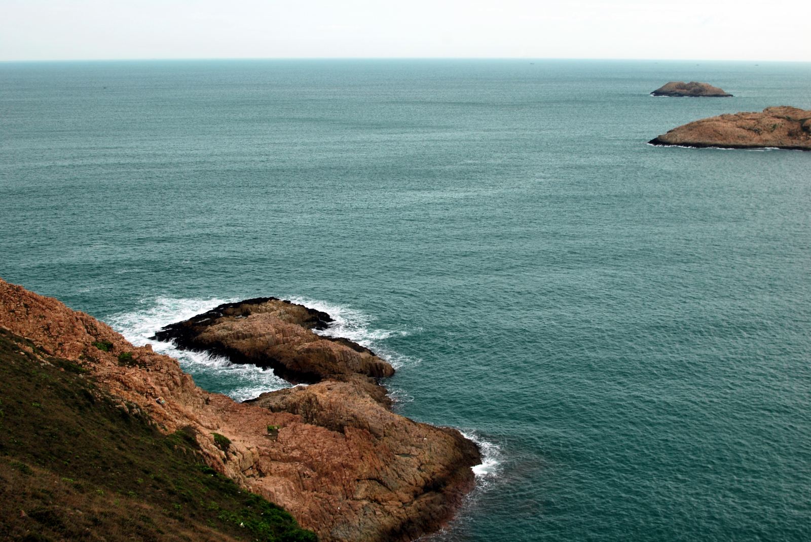 Aerial view of a rocky headland and offshore islets on Hong Kong's coast